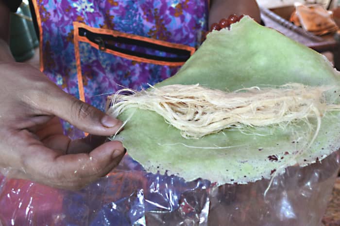 The 'roti saimai' prior to wrapping. Pandanus leaf extract provides the colouring