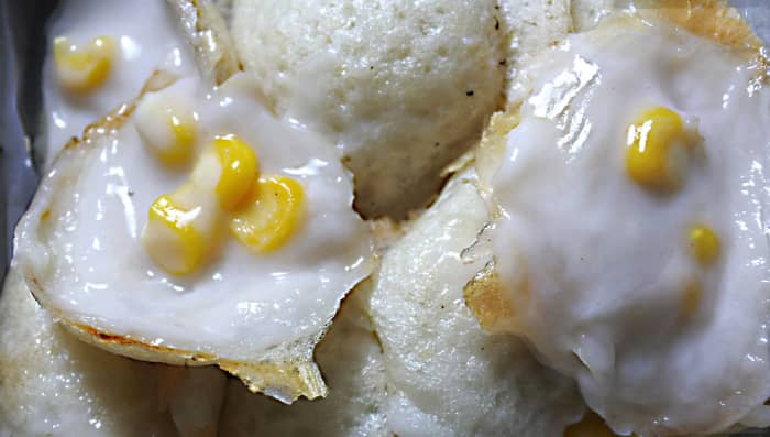 The coconut and rice pudding 'khanom krok'. The sweet corn topping is not strictly necessary, but adds visual attraction and texture. Since first writing this article I have sampled khanom krok many times and itis now my favourite Thai dessert