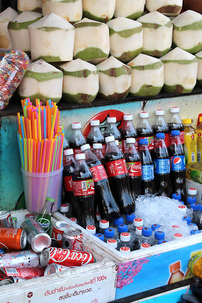 Drinks, Western and traditional. Behind the bottled water and the Coca Cola are the more authentically Thai coconuts