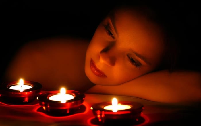 Woman with candles If we didn't have electricity we would be using candles and no technology imagine that!