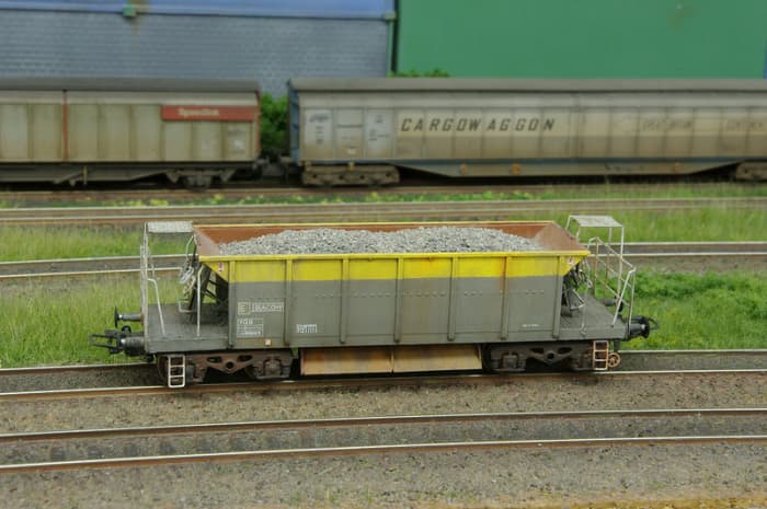 A well detailed post-privatisation Departmental Seacow ballast hopper is shown off in this view, with a pair of private owner bogie wagons in the background