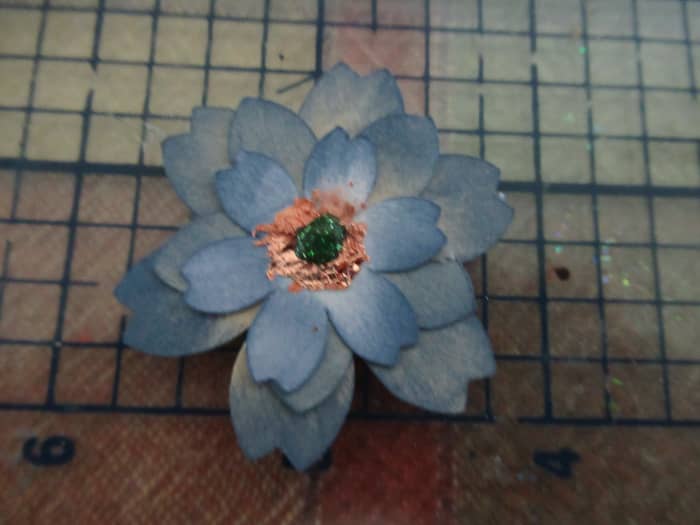 I created these flowers with a simple punch. They were colored with distress ink. Gilding flakes were added to the center.