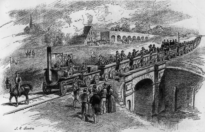 Skerne Bridge near North Road Station, Darlington seen from the north side, with the inaugural train from Shildon driven by George Stephenson. The bridge appeared on the previous £5 note behind the portrait of the great man