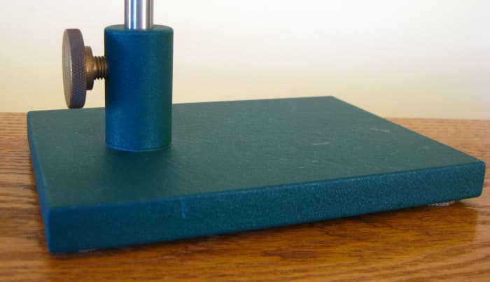The Spartan vise can be purchased with either the heavy pedestal base shown here, or a c-clamp. This base is green because it is the Orvis edition. Normally the base is black. An optional polished brass base is available as well.