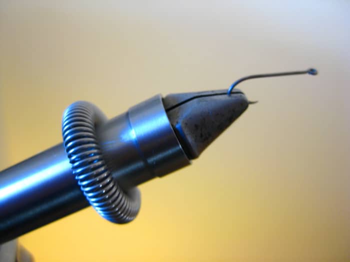 The HMH vise comes with a heavy spring material clip to hold hackles, tinsels and other materials out of the way when tying.