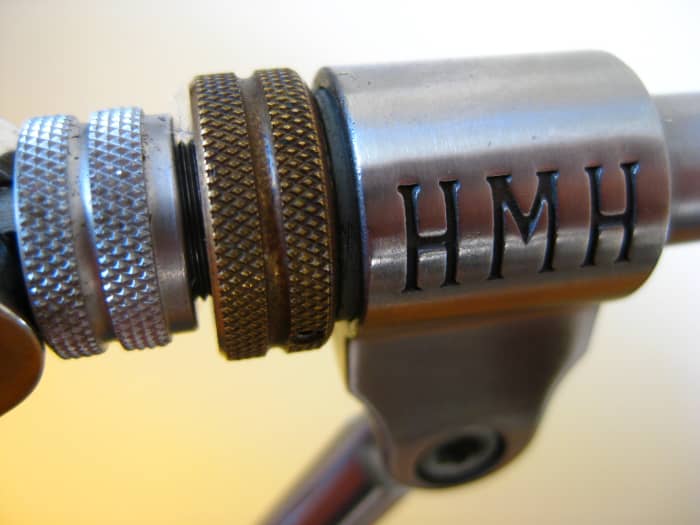The brass set ring on the lever side of the chassis adjusts the rotational tension of the jaw assembly. A set screw on that ring allows that tension level to be fixed according to the preference of the tyer.