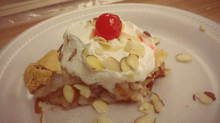 This photo of the Washington apple pie with Oregon cherries and California dairy whipped cream and almonds was taken by Victoria, one of the mothers in our co-op class.