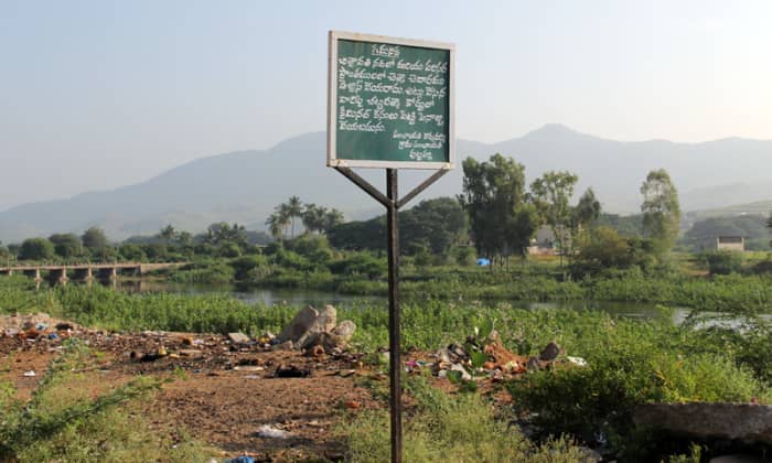 A joke? Do you understand what is written on the board? Even those who can read Telugu don't seem to care for its request to keep the river clean or face dire consequences (??)