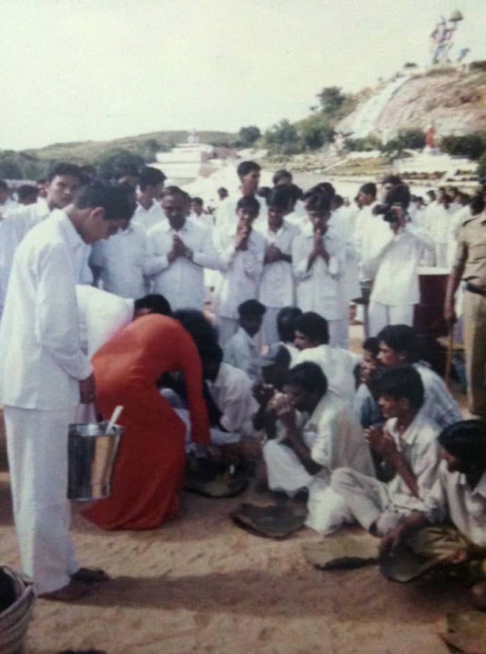 I enjoyed the privilege of taking photos as well on that Narayan Seva day. (Seen in this picture, opposite to Swami with a camera to my face!)