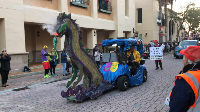 By attaching a platform to the front of the golf cart, they provided room for this fire-breathing dragon. Very creative.