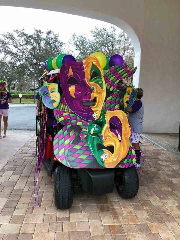 Clever placement of the giant masks leaves several openings so the driver can see to drive the golf cart.