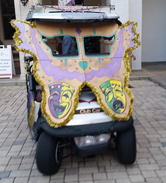 Giant butterfly design in Mardi Gras colors with cut-out windows for the driver to see out.