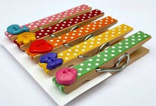 Cover a clothes pin with ribbon and buttons. Use them on a desk or add a magnet to use on a refrigerator