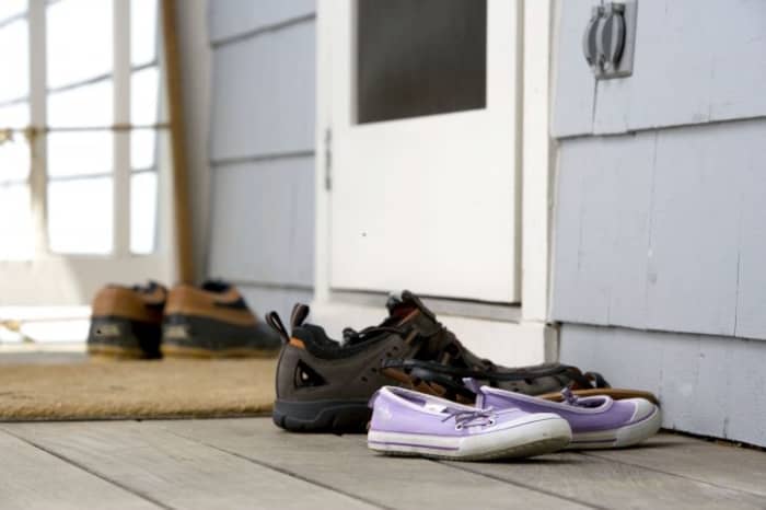 The best practice you can institute is to ask everyone to remove their shoes before entering the house to reduce the risk of bringing contaminants into the home. Clean shoes with a sanitizing shoe mat, sanitizer wipes or a sanitizer sprayed on the