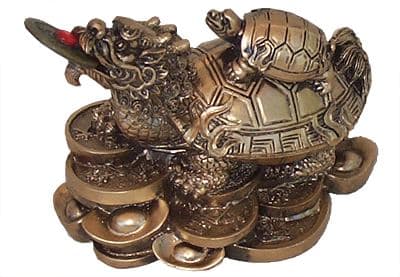 Dragon turtle standing on bed of coins and ingots with a baby Tortoise on its back is a symbol of good luck, longevity, protection, harmony and money in Feng Shui.