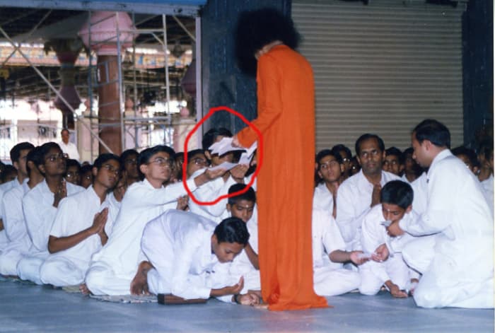 Somebody captured me giving my 'conditional letter' to Swami. My face is hidden by His hand. The Kulwant hall, where works were on can be seen in the background.