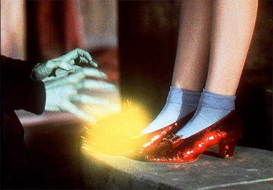 Wizard of Oz ruby red slippers and the green witches hands being repelled by the power of the slippers