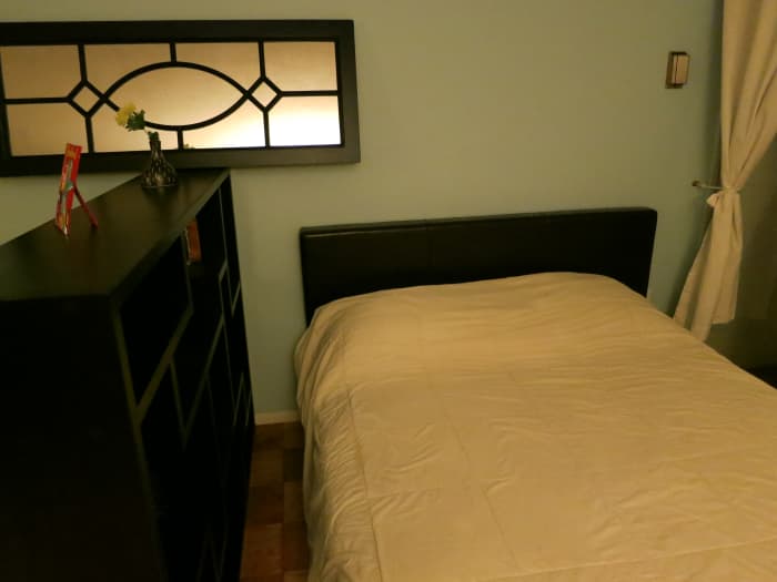 Here's my queen-size bed, which fits perfectly in my studio and the divider gives my sleeping area some privacy