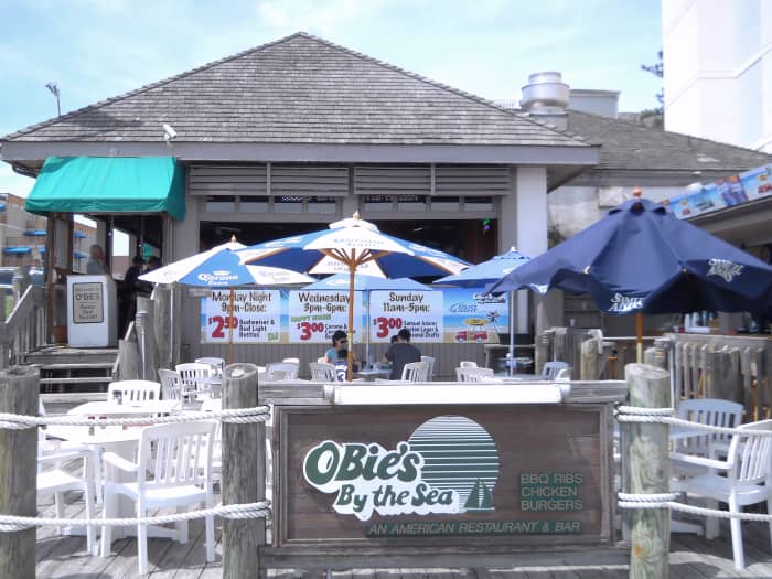 Outdoor seating has colorful umbrellas for shade. Indoor seating overlooks the ocean and the upper half of the walls are open providing an "outdoor" feel even though you're sheltered.