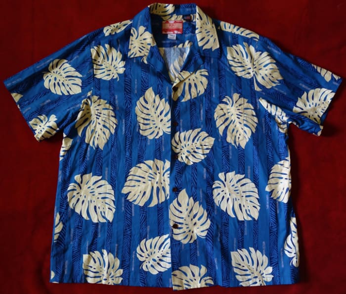 Mens Hawaiian Aloha Shirt from RJC - Made in Hawaii of 100% Cotton. With a beautiful sea blue color print with Tropical Palm leaves.