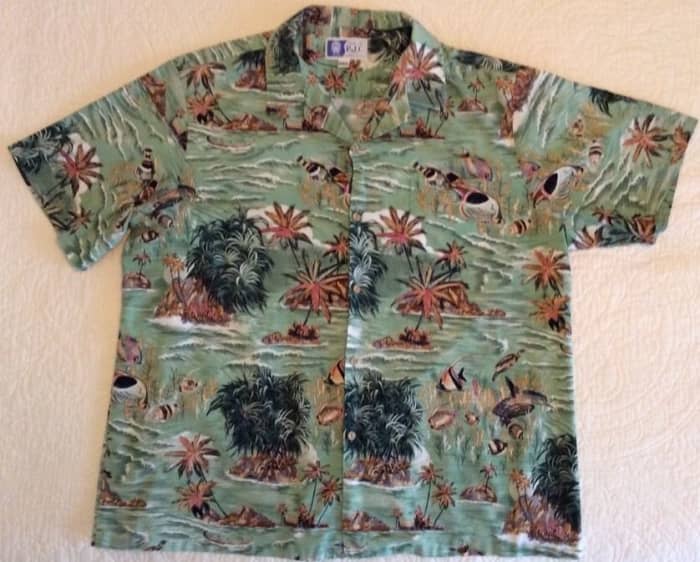 A RJC Mens Hawaiian Aloha Shirt. Made in Hawaii. This beautiful Shirts features Tropical Fish, Boats in colors of light green dark green, tan, brown and white. Front left pocket., and it is 100% Cotton.