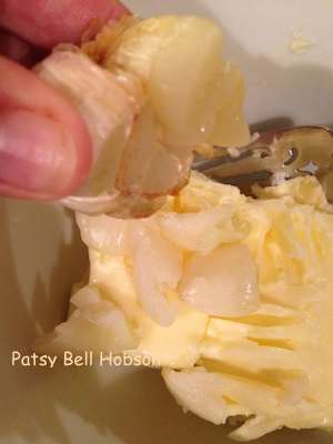 Squeeze roasted garlic bulbs. Mix garlic with butter. Reshape into a stick or log. Refrigerate or freeze.