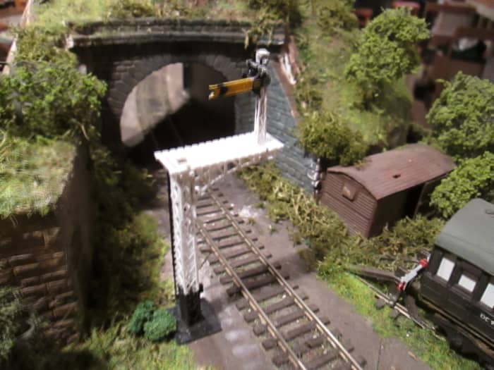 The tunnel mouth exit at Ayton Lane mpd with the bracketed distant 'on' (Ratio kit). Van body with weathered and 'rust perforated' corrugated (aluminium) roof; scatter, lichen and trees. Track to be ash/cinder ballasted