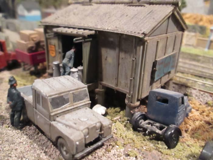Ayton Row's provender store (Ratio) with ballast road, metal kit-built 'mechanical horse' in LNER blue livery, Oxford 4mm Land Rover pick-up, white metal painted figures, plastic milk churns from Peco'
