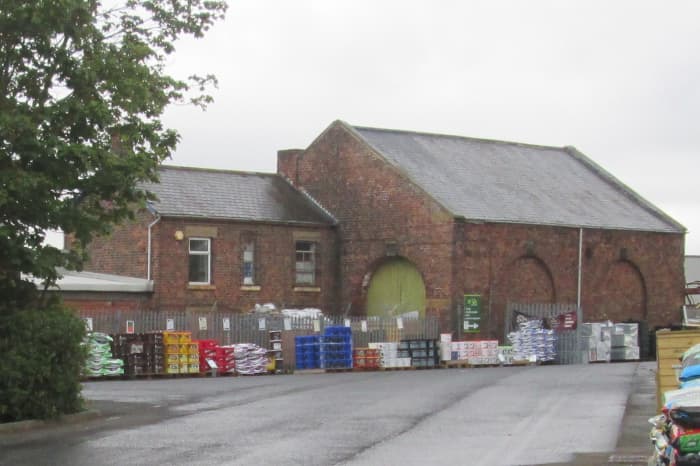 The goods shed and yard now stores building materials etc. The arch at this end was where wagons were shunted through or out. Access for carts, later lorries, was on the far side.