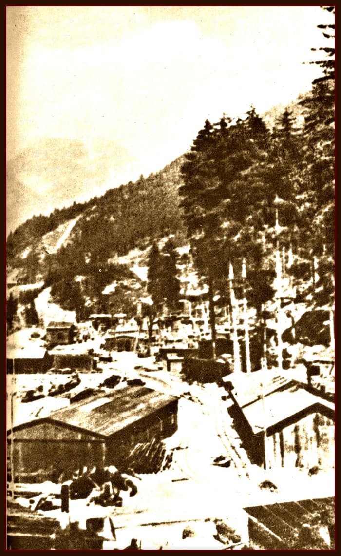 Ebensee, work yard at the tunnel entrance, "In front of the wall, an immense space growing day by day. Above rail tracks, trains, tip-carts, barracks, transformers, electric cables, projectors. In the midst of this clutter men bent under their loads