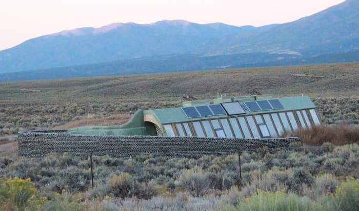 Earthship near Taos, New Mexico. Note the greenhouse that spans one whole side of the ship; the inhabitants are meant to grow their own food.
