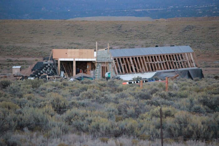 Earthships of Taos, New Mexico. A wood-framed Earthship in progress. The wood framing is probably required by building codes.