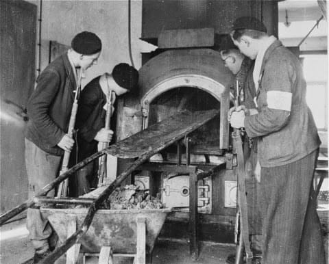 French Resistance fighters inspect one of the ovens in the Crematorium of Natweiler -Struhof Concentration Camp, Alsace N E France