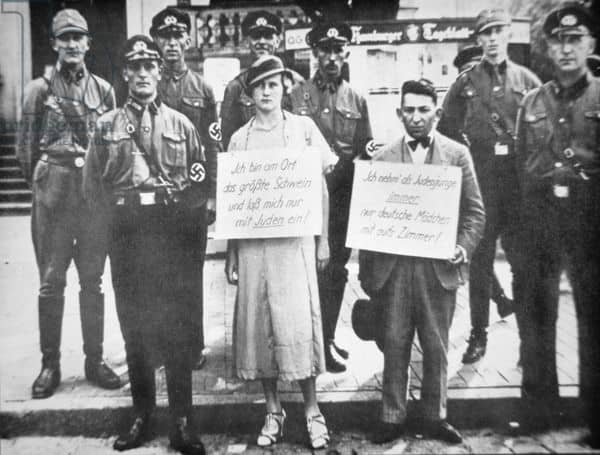 15 Sep Nuremberg Laws deprive German Jews of citizenship. This is an image of Nazi police publicly humiliating and shaming a German woman and a Jewish man for sleeping together.