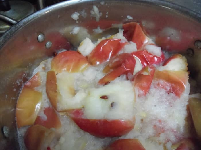I use a stock pot to cook the apples in to assure enough space and avoid it from boiling over. You can lower heat even further if needed.