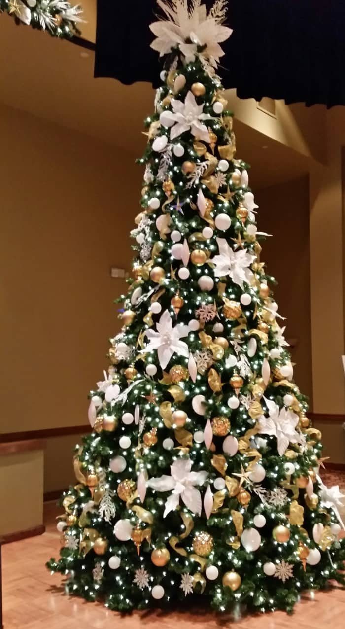 A tree at Solivita that's loaded with bling with lots of gold and shiny white covering every inch of the oversize tree.