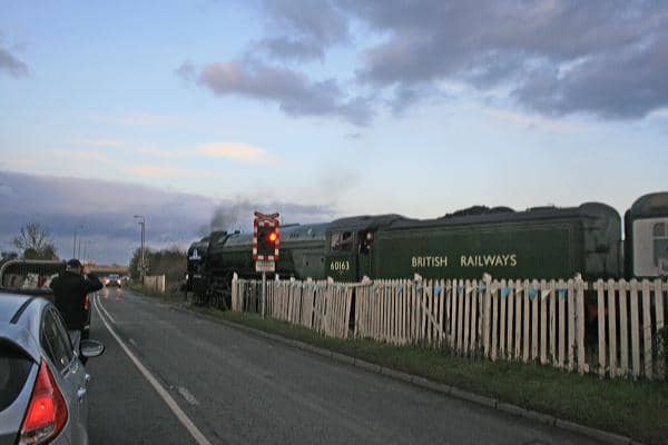Tornado' trundles onto Aiskew Crossing (with the warning lights flashing) on her way between Leeming Bar and Bedale with a train for Redmire