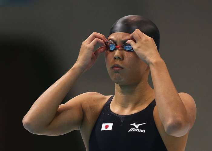 Natsumi Hoshi adjusts her goggles prior to the second heat of the 200 meter Women's Butterfly swimming competition in the 2012 Summer Olympics in London, England.
