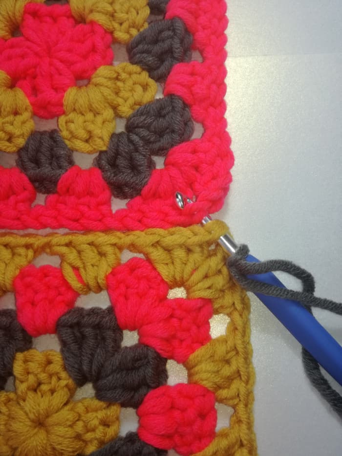 Image 1. Insert hook in the second stitches of both granny squares of the 2 chain corner & work a double crochet.