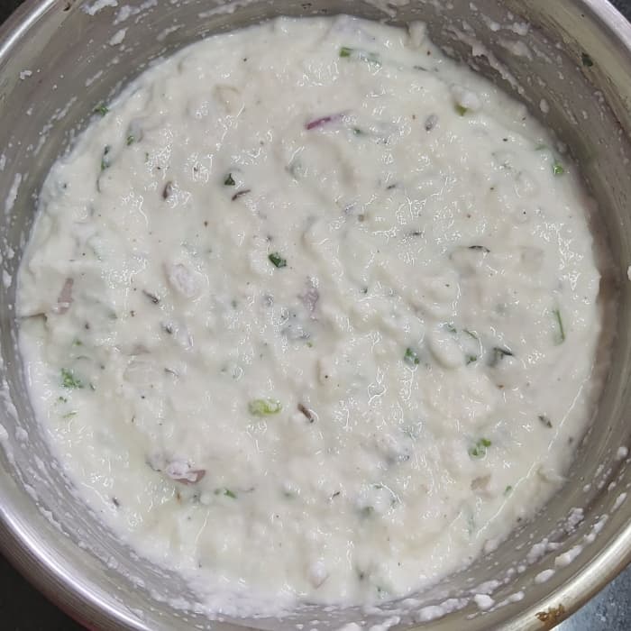 Mix everything properly to form smooth batter. Don't add water. Cover and keep aside for 15-20 minutes or until rava is soaked well.