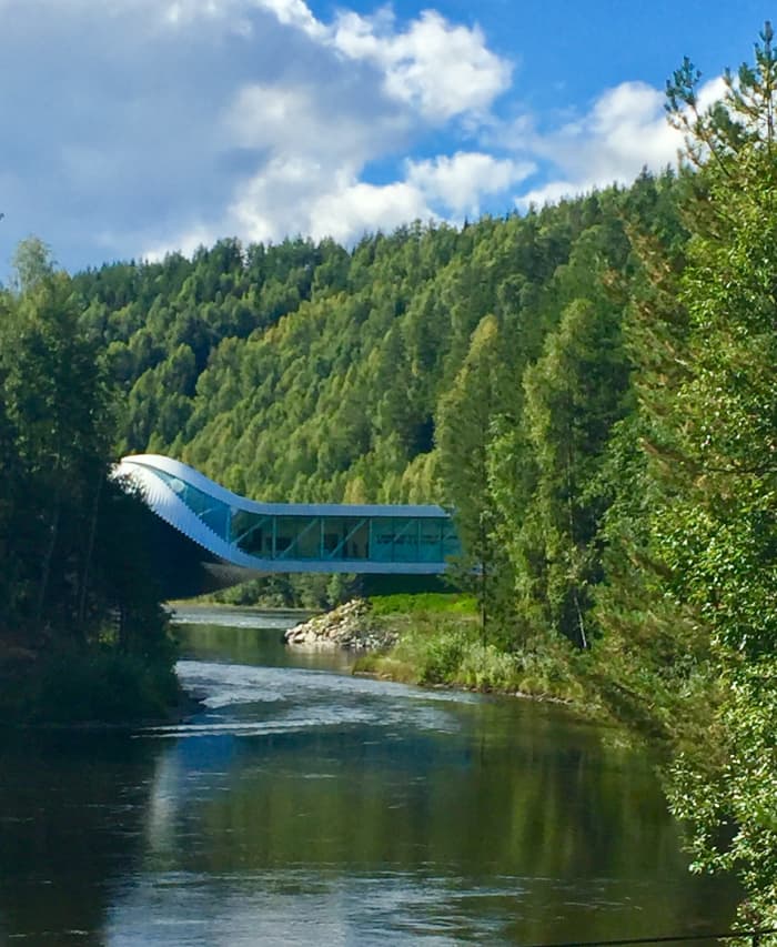 The Danish architecture firm Bjarke Ingels Group’s building twists and spans 60 meters across the Randselva river, where it makes a harmonious interplay with the area's beautiful woodland nature.
