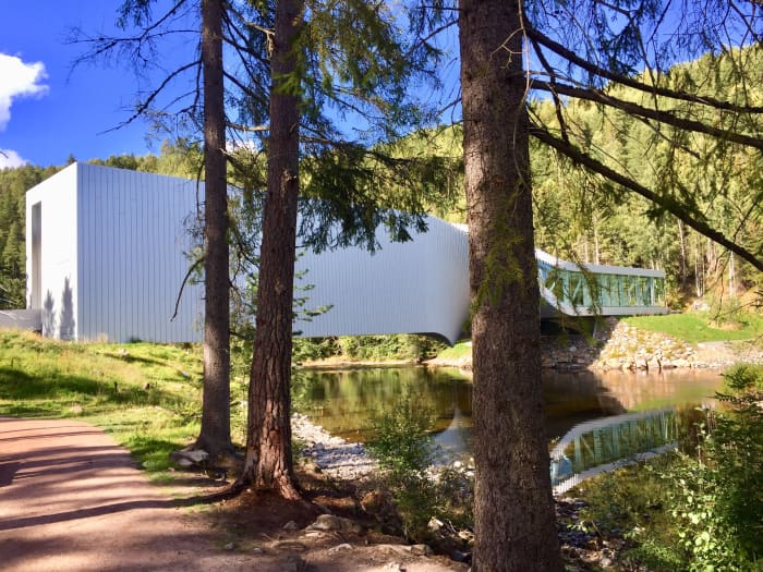 Visitors enter The Twist from the south side of the river through a double-high dramatic space. Idyllic paths and forests surround the building.
