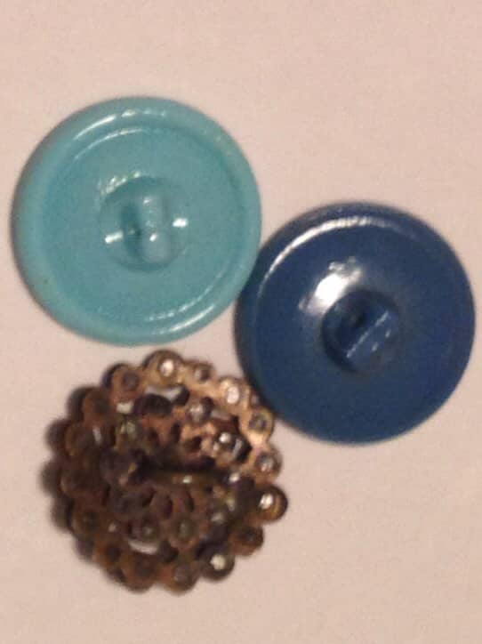 The blue glass Czech buttons are examples of self-shank buttons. These work well for jewelry stringing.