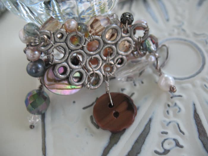 Here you can see the back side of the brooch pictured above. I used 24 gauge wire to secure the beads in place and hold the pin backing on. The higher the number for a wire's gauge, the thinner the wire.