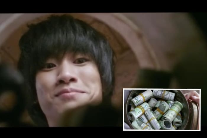Lieutenant Won Ryu Hwan/ Bang Dong Gu looking at his savings, anticipating he'll be rich when he goes home to North Korea.