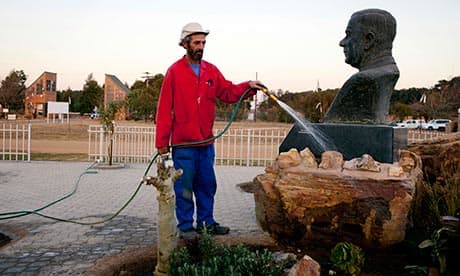 A municipality worker waters a monument to the former prime minister of South Africa Hendrik Verwoerd at the gate to Kleinfontein community, outside Pretoria, South Africa.