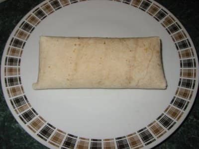 Fold your top flap down and turn your chimichanga over to hold the flaps in. Let them rest this way on a tray in the refrigerator 45 minutes before you deep fry them.