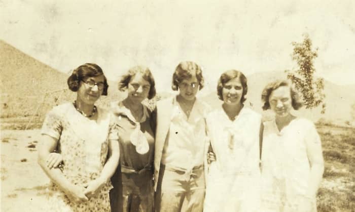 Bertha McGhee is the one in the dark dress with the sailor tie. I see a little plaid pattern in that dress. I'm not sure which names go to which teachers in this photo yet.