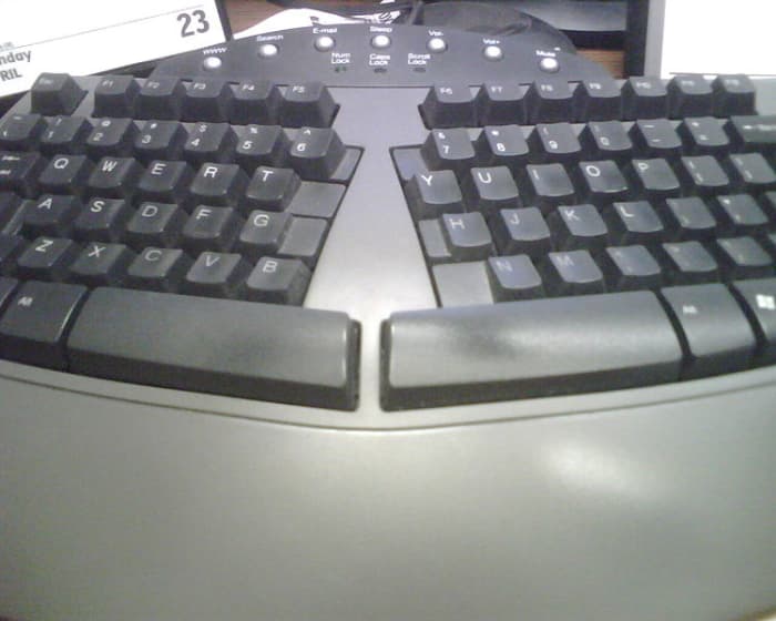 An ergonomic keyboard is designed to minimize muscle strain by creating a shape that is natural to the hands.