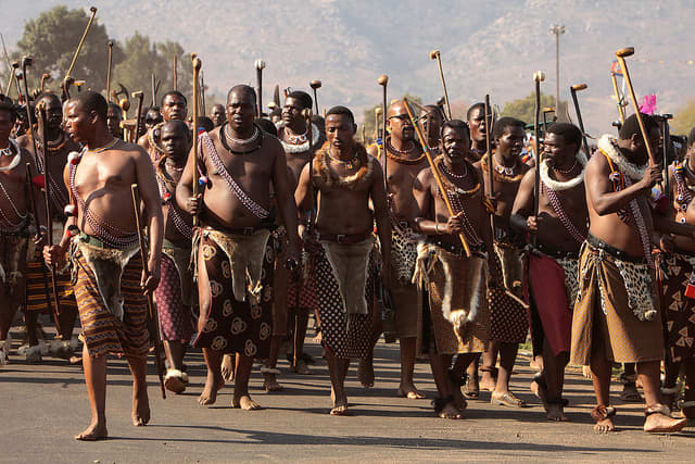 Adorning their cultural gdb and marching in the reed carrying their traditional sticks, The elderly men march on in the Reeds Festivities, bare-footed